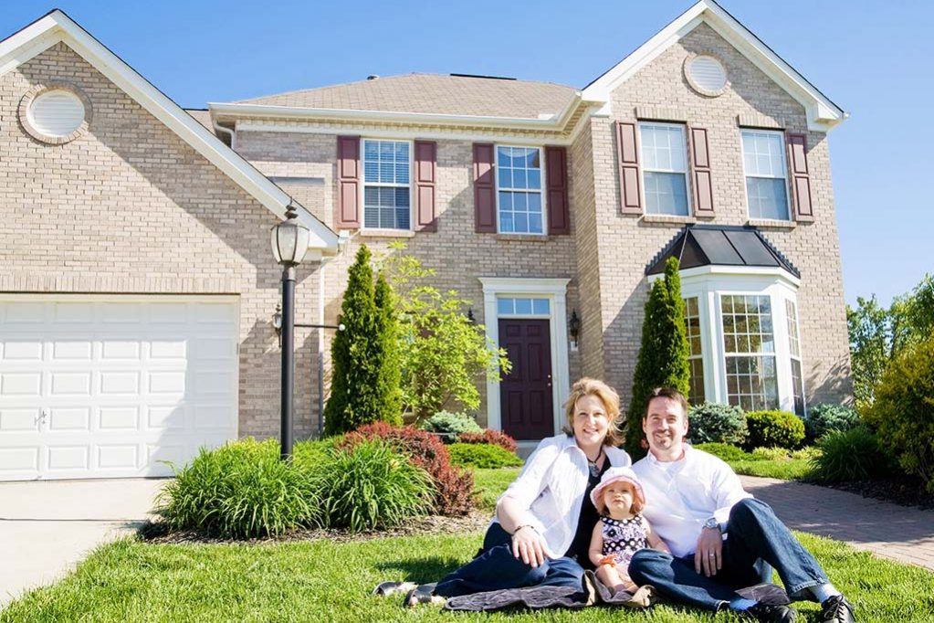 Family In Front Of House