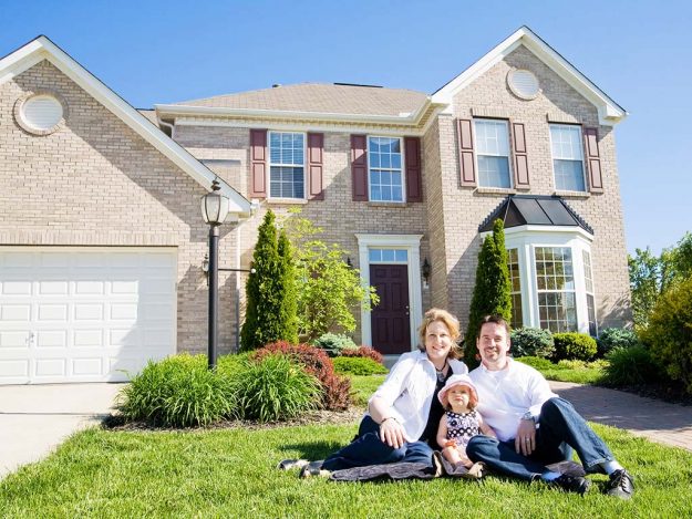 Family In Front Of House